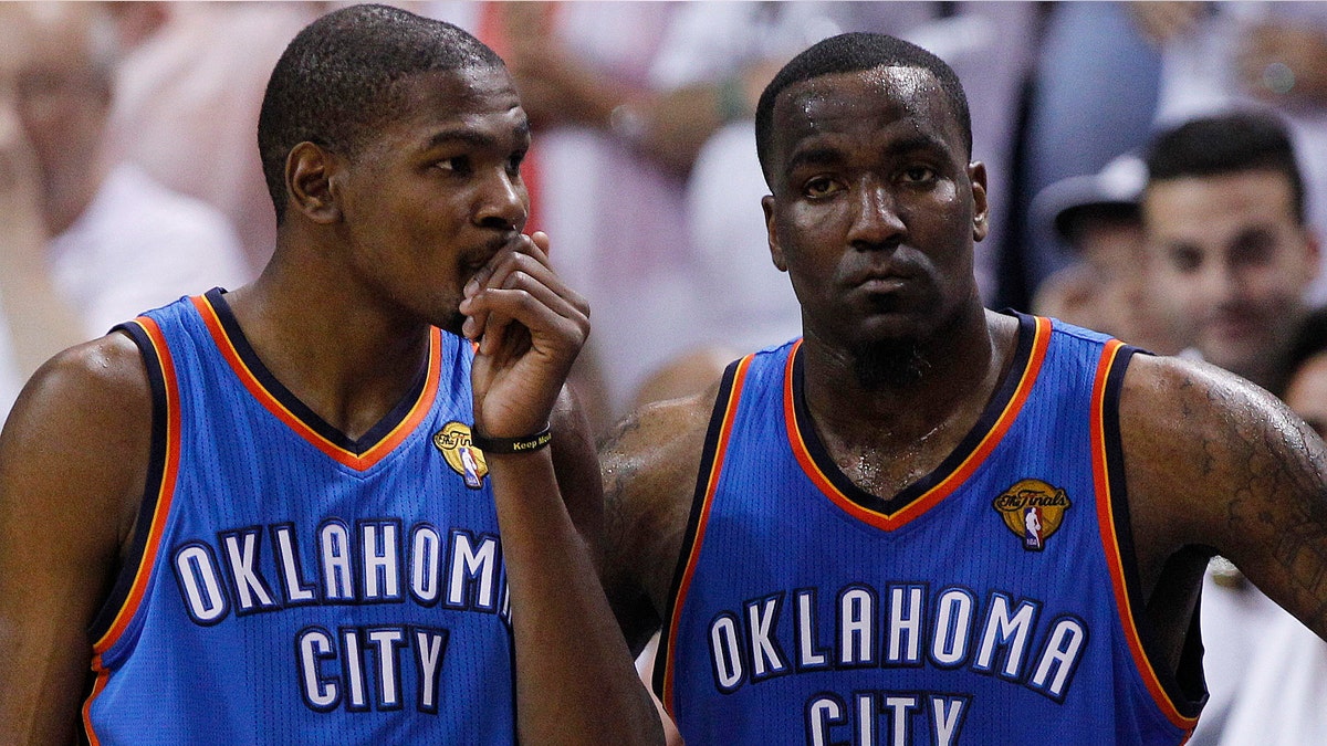 Oklahoma City Thunder small forward Kevin Durant (35) and center Kendrick Perkins (5) react against the Miami Heat during the second half at Game 3 of the NBA Finals basketball series, Sunday, June 17, 2012, in Miami. Miami won 91-85. (AP Photo/Lynne Sladky)