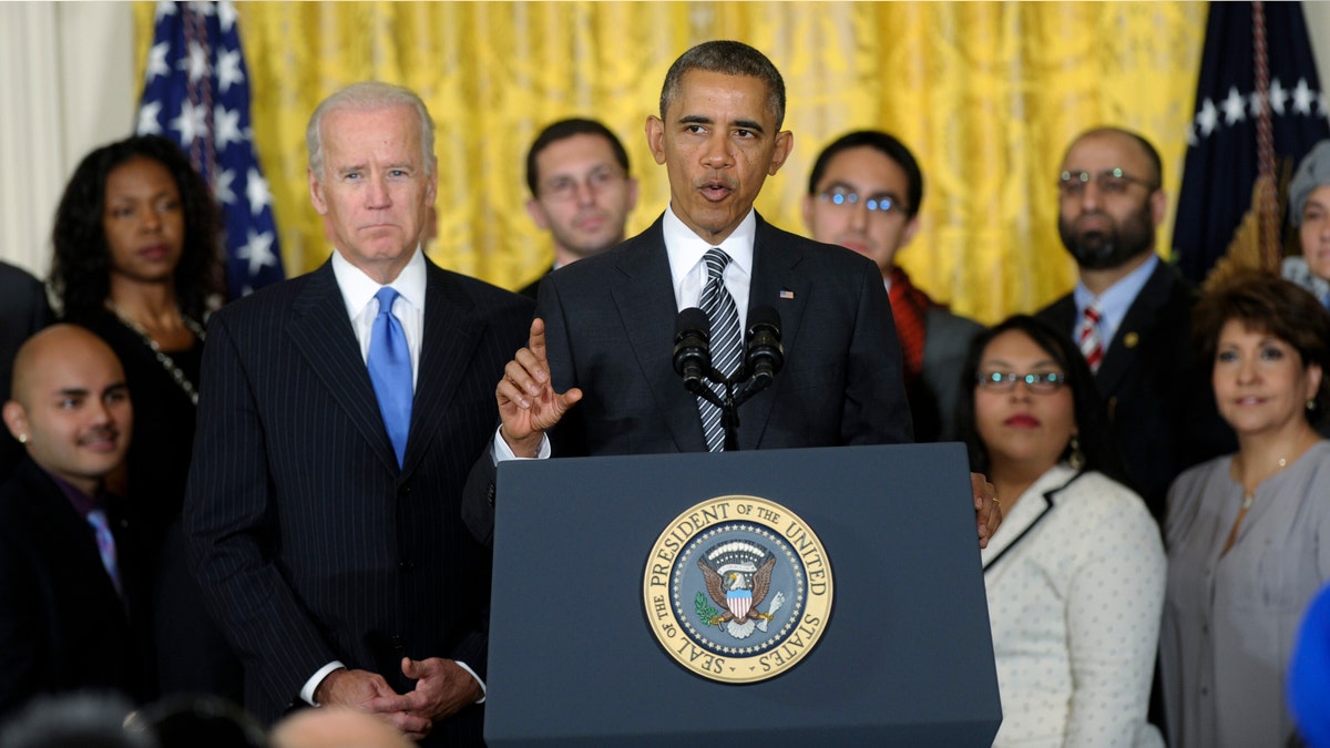 President Barack Obama, standing next to Vice President Joe Biden, urges Congress to take back up comprehensive immigration reform while speaking in the East Room of the White House in Washington, Thursday, Oct. 24, 2013. Obama said now that the partial government shutdown is over, Republicans and Democrats should be able to work together to fix what he called 