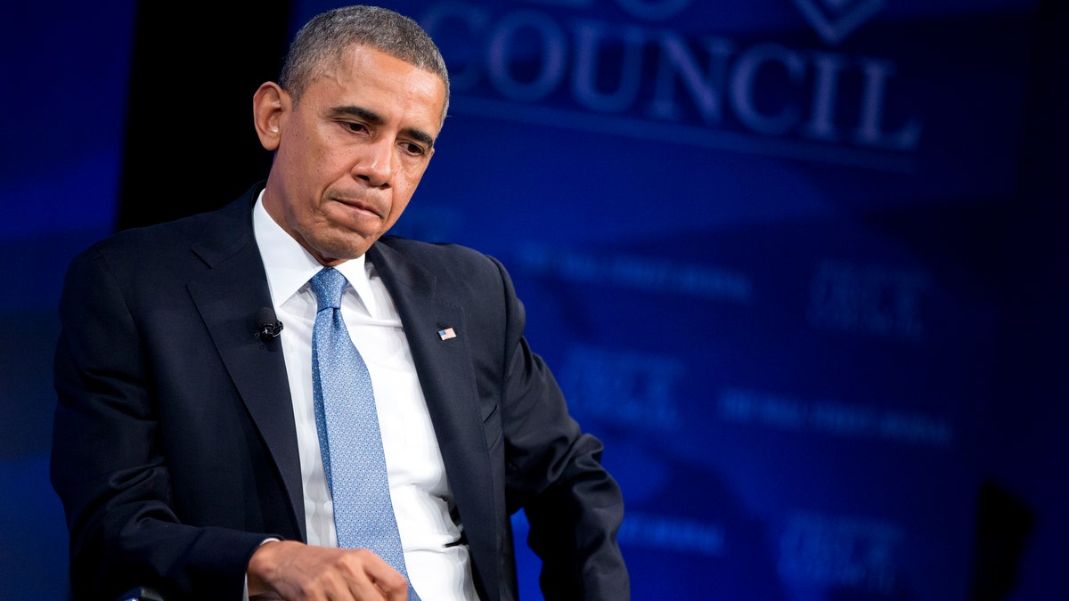 President Barack Obama stopped when he heard about corporate tax reform at the annual meeting of the Wall Street Magazine CEOs’ Committee on Tuesday, November 19, 2013. Obama also discussed the economy, new health care laws, immigration reform and negotiations with Iran on its nuclear program. (AP Photo/Evan Vucci)