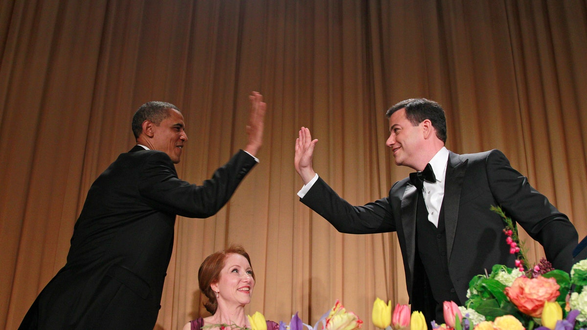 President Barack Obama high-fives late-night comic Jimmy Kimmel as Caren Bohan, a Reuters journalist and president of the White House Correspondents' Association looks on during the White House Correspondents' Association Dinner, Saturday, April 28, 2012 in Washington. (AP Photo/Haraz N. Ghanbari)