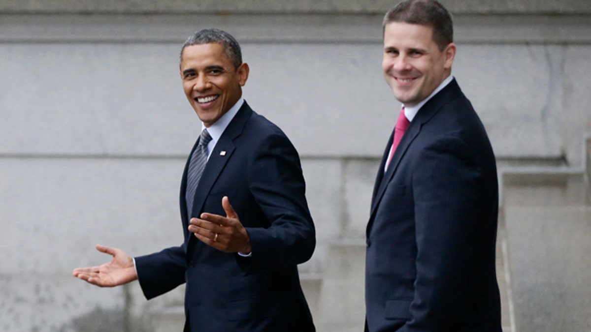 Jan. 16, 2013: President Barack Obama, accompanied by White House Communications Director Dan Pfeiffer, reacts to a reporter's question about the event he was leaving at the Treasury Department.