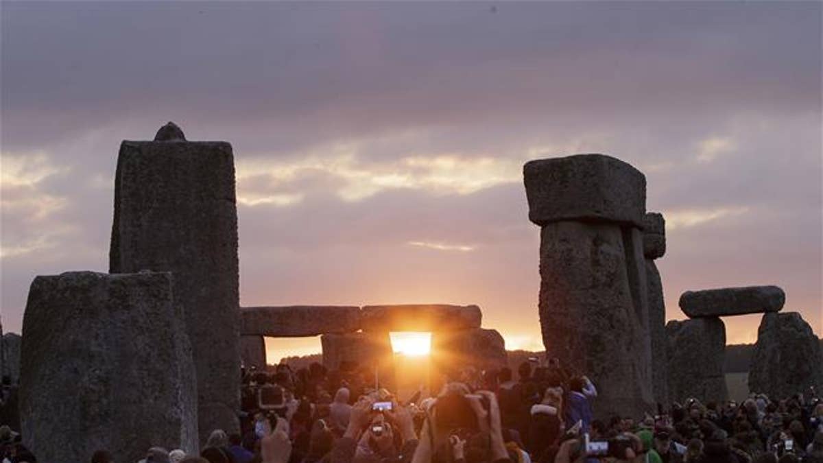 In this June 21, 2015, file photo, the sun rises as thousands of revelers gathered at the ancient stone circle Stonehenge to celebrate the Summer Solstice.