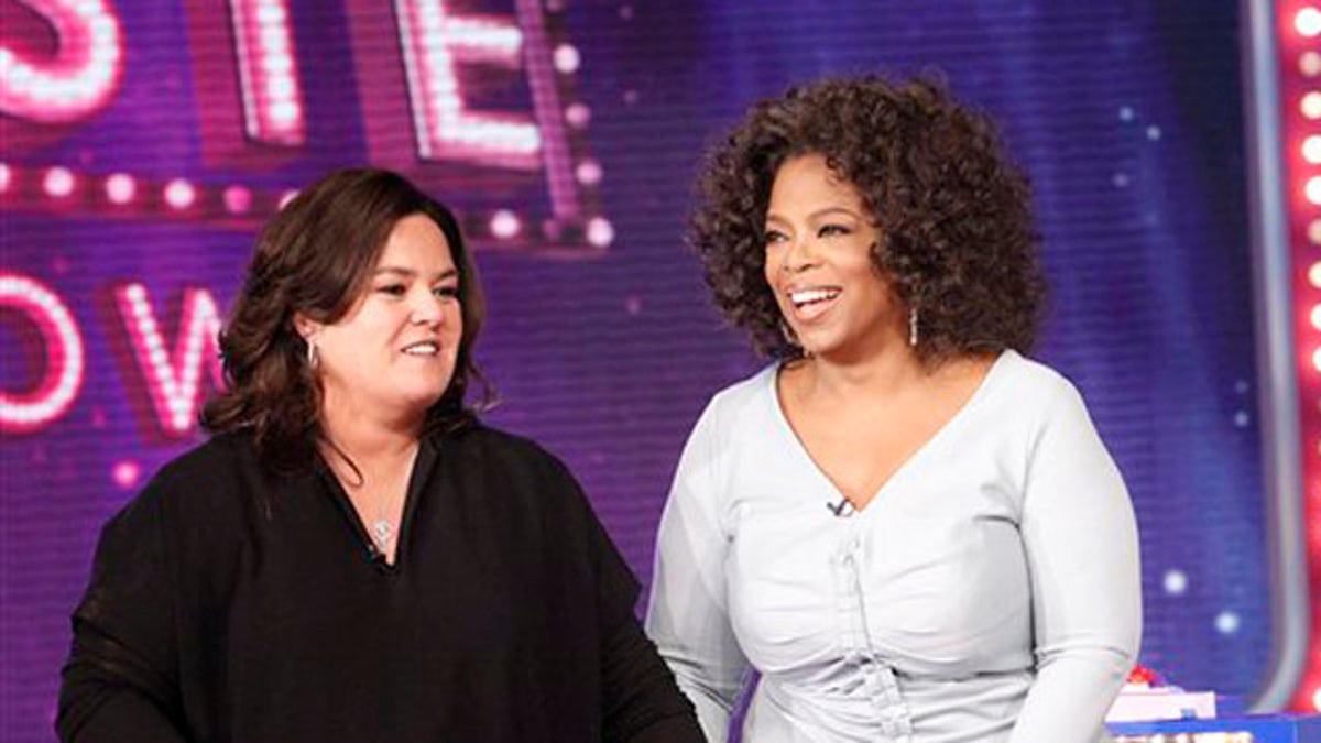 FILE - In this Oct. 10, 2011 file image released by Harpo, Inc., Oprah Winfrey, right, is shown with host Rosie O'Donnell during the debut of