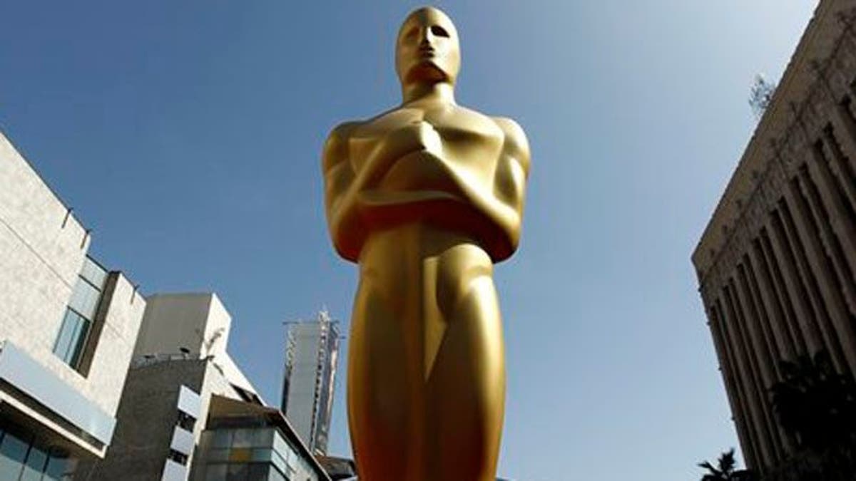 FILE - In this Feb. 25, 2012 file photo, a Oscar statue is seen on the red carpet before the 84th Academy Awards in Los Angeles. The producers of the 86th annual Academy Awards say this year's ceremony will honor big-screen, real-life heroes, superheroes, popular heroes and animated heroes, both past and present, as well as the filmmakers who bring them to life. Craig Zadan and Neil Meron said Tuesday, Jan. 14, 2014, that they wanted to unify the March 2 show with an entertaining and emotional theme. (AP Photo/Matt Sayles, File)