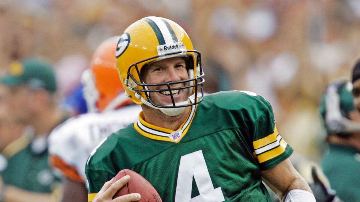 <p>Brett Favre laughs after rushing for a first down against the Cleveland Browns on Sept. 19, 2005, in Green Bay, Wis.</p>