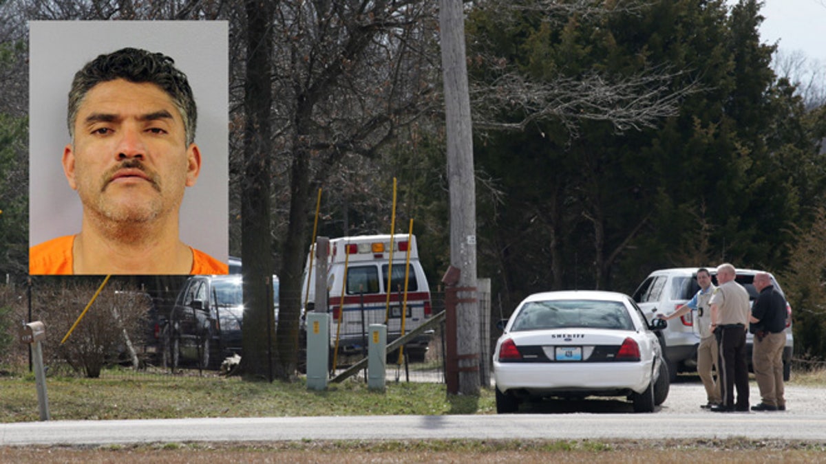 Police gather near the house where a man was found murdered on Tuesday, March 8, 2016, near New Florence, Mo., just south of Interstate 70 near the intersection of Highway 19. Dozens of officers searched farmland in central Missouri on Tuesday for a man suspected of killing a man at a nearby house just hours after fatally shooting several people at his neighbor's home about 170 miles away in Kansas.    (Cristina Fletes/St. Louis Post-Dispatch via AP)  EDWARDSVILLE INTELLIGENCER OUT; THE ALTON TELEGRAPH OUT; MANDATORY CREDIT