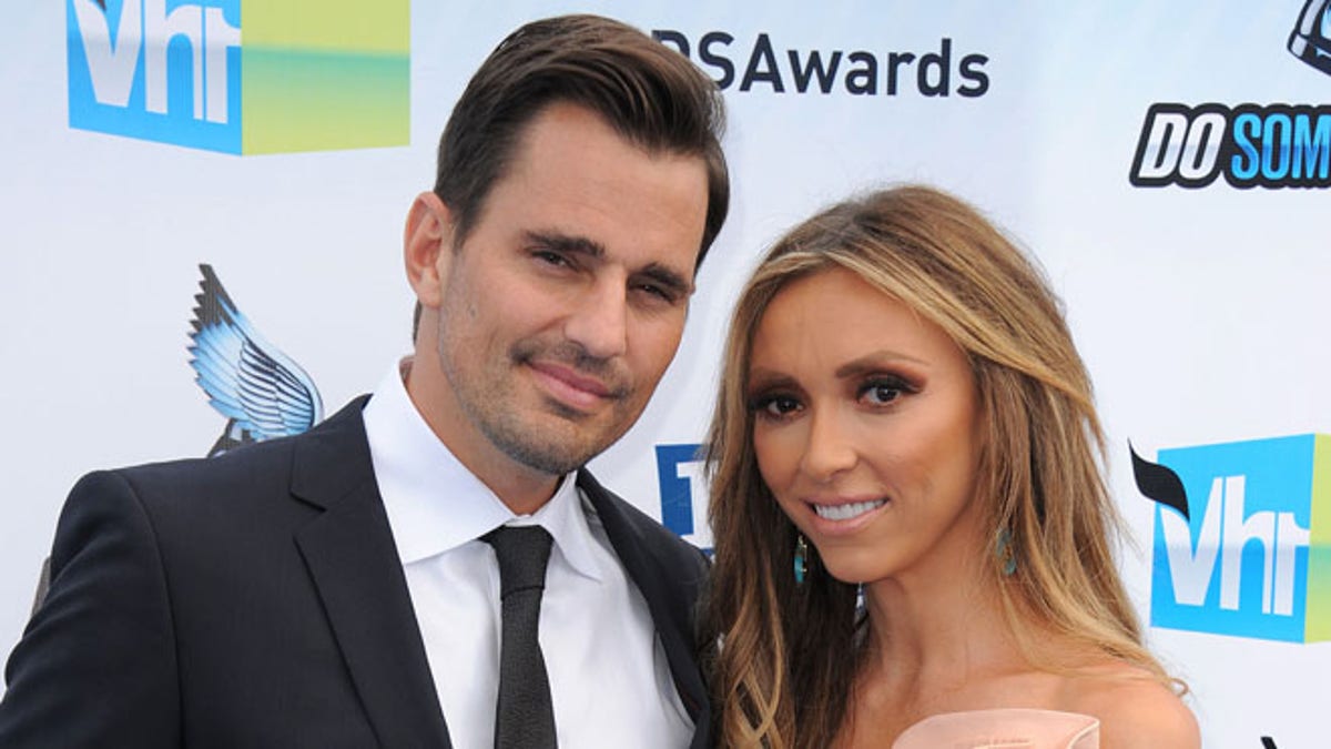 FILE - This Aug. 19, 2012 file photo shows Bill Rancic, left, and his wife Giuliana Rancic attending the 2012 Do Something awards in Santa Monica, Calif. The couple have welcomed son Edward Duke to their family.  Edward was born in Denver via a gestational surrogate on Wednesday, Aug. 29. He weighed 7 pounds and 4 ounces. The couple was in the delivery room for the four-hour labor and birth. Giuliana Rancic is a red-carpet fixture and host of E! News, and Bill is an entrepreneur and motivational speaker, who was the first-season winner on TV's The Apprentice.  Together, they star in a Style Network reality show called Giuliana & Bill that dealt with their fertility issues. (Photo by Jordan Strauss/Invision/AP, file)