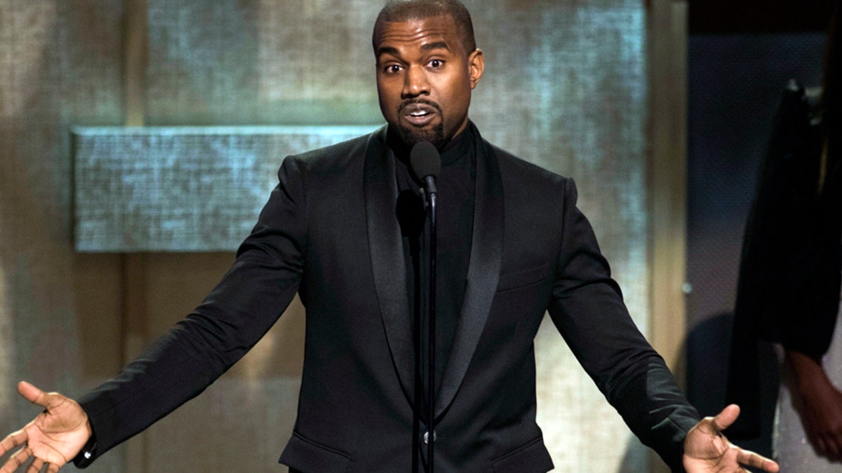 FILE - In this Jan. 24, 2015, file photo, BET Honoree Kanye West accepts the Visonary Award at the BET Honors 2015 at Warner Theater in Washington. West on Tuesday, April 7, 2015, settled a lawsuit filed by a paparazzo who the rapper attacked outside a Los Angeles International Airport terminal in 2013. Daniel Ramos' attorney Gloria Allred wrote in a statement that the suit was settled in part after West apologized to her client and the pair shook hands. (Photo by Kevin Wolf/Invision/AP, File)