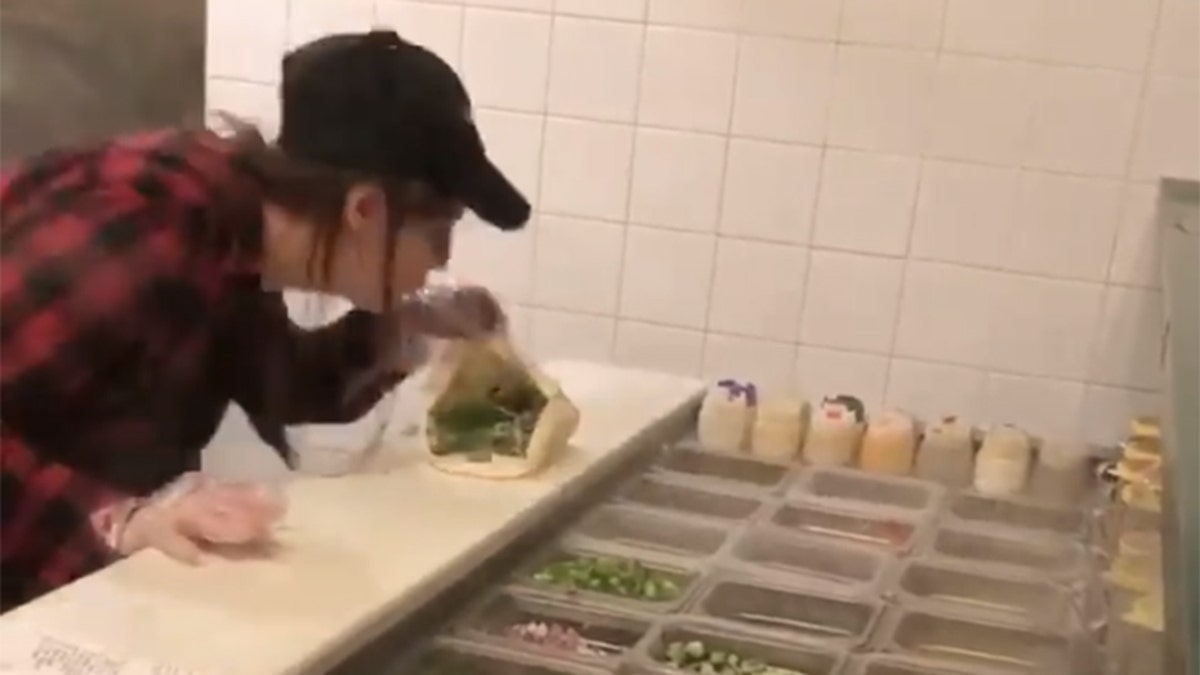 A video has gone viral showing a Pita Pit employee spitting on a customer's sandwich after an altercation.
