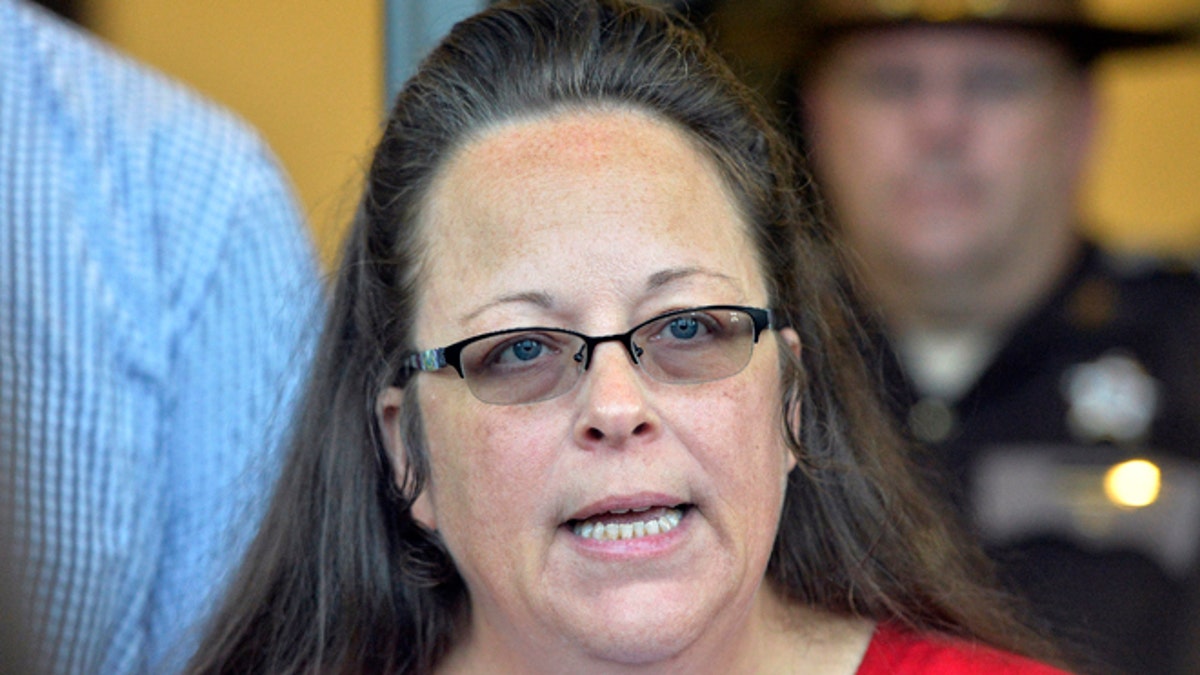 Rowan County Clerk Kim Davis makes a statement to the media at the front door of the Rowan County Judicial Center in Morehead, Ky. Davis, who refused to issue marriage licenses to same-sex couples, says she met briefly with the pope during his historic visit to the United States. (AP Photo/Timothy D. Easley, File)