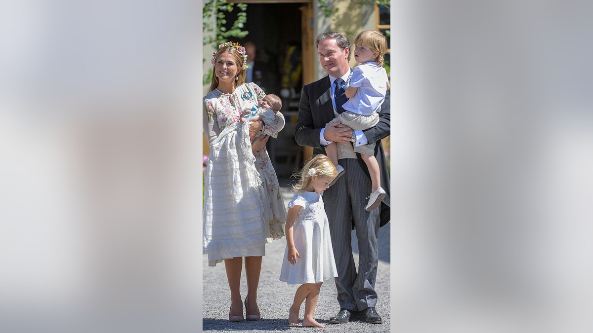 Sweden's Princess Madeleine, left holding Prince Nicolas stands next to her  husband Christopher O'Neill holding their daughter Princess Leonore, with  Queen Silvia and King Carl XVI Gustaf at right, during the christening