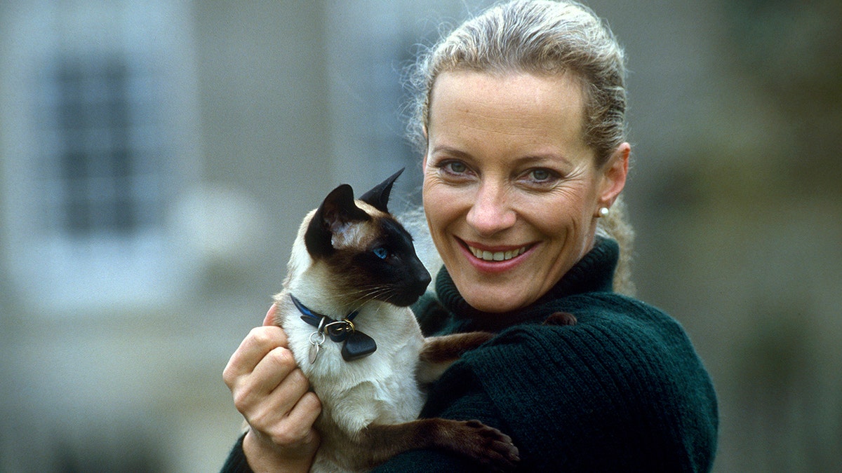 UNITED KINGDOM - NOVEMBER 04:  Princess Michael Of Kent Holding Her Pet Siamese Cat In The Gardens Of Her Home, Nether Lypiatt Manor.  The Princess Is Wearing A Dark Green Wool Cardigan And Matching Scarf.  (Photo by Tim Graham/Getty Images)