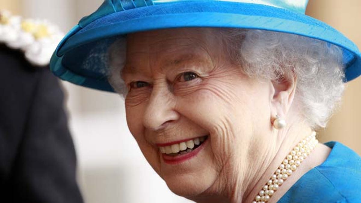 June 23, 2014: In this file photo, Britain's Queen Elizabeth smiles to the media as she arrives at Hillsborough Castle, Northern Ireland.
