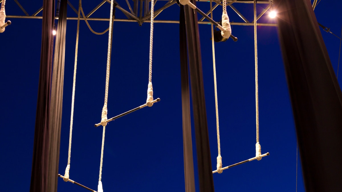 Empty standing trapezes against dark blue sky at twilight