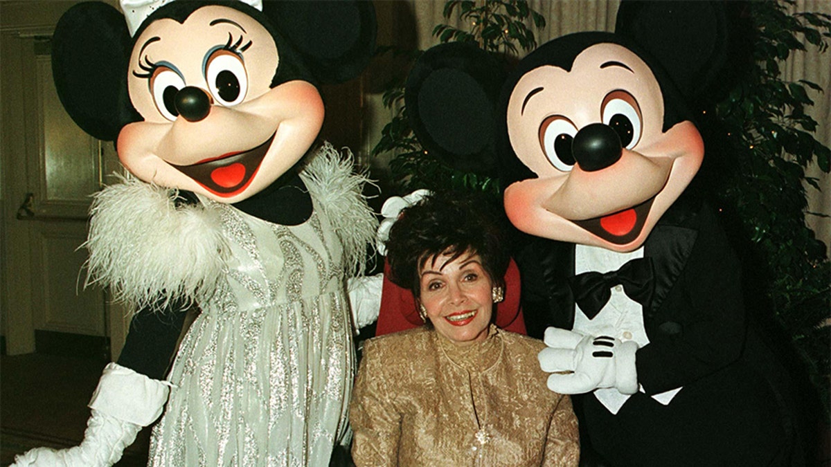 Actress Annette Funicello poses with Disney characters 