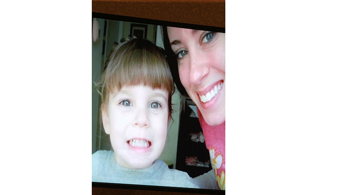 An image displayed on a courtroom monitor shows a photo entered into evidence in the Casey Anthony trial showing the late 2-year-old Caylee Anthony with her mother Casey at the Orange County Courthouse on Friday, June 10, 2011. Celebrity medical examiner Jan Garavaglia testified on Friday that bones scattered in woods near Anthony's home were positively identified as those of her 2-year-old daughter Caylee.  REUTERS/Joe Burbank/Pool   (UNITED STATES - Tags: CRIME LAW SOCIETY) - GM1E76B0U0J01
