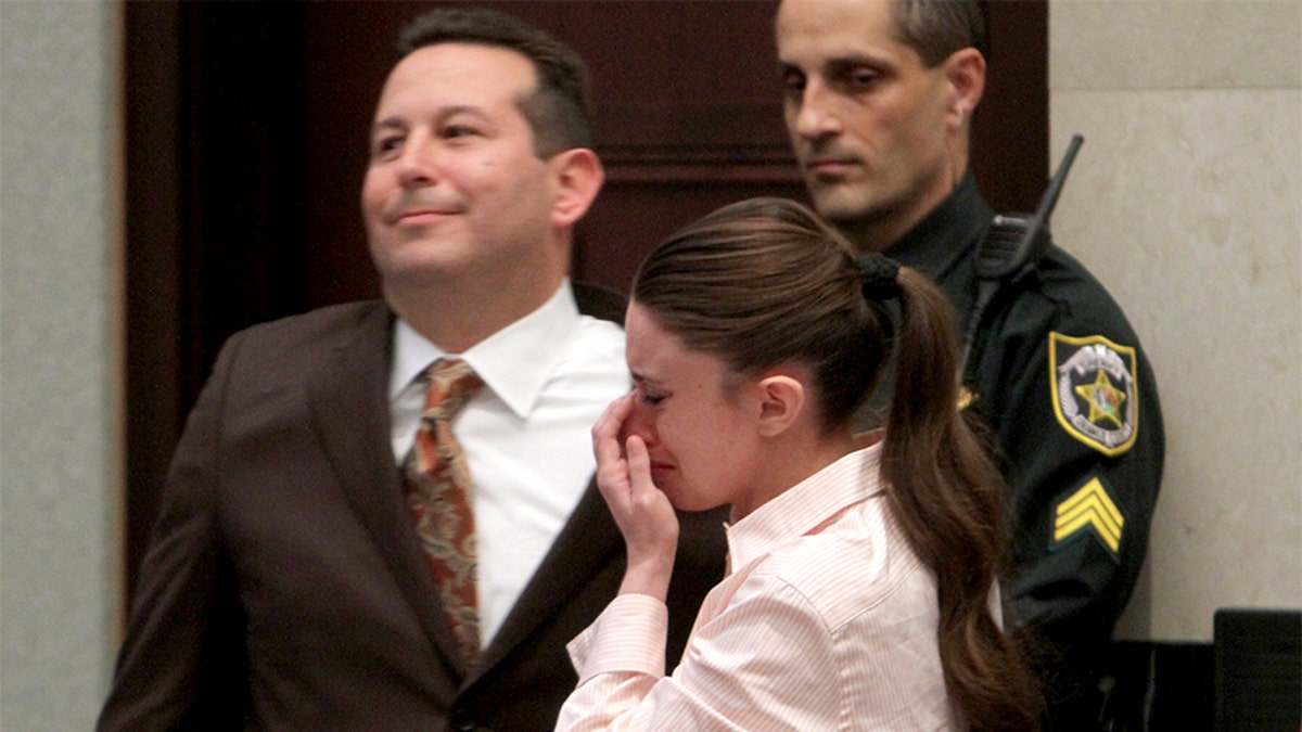 Casey Anthony cries next to her attorney Jose Baez (L), after she was acquitted on first degree murder charges of her daughter Caylee at the Orange County Courthouse Orlando, Florida July 5, 2011. REUTERS/Red Huber/Pool (UNITED STATES - Tags: CRIME LAW) - GM1E7760CJW01