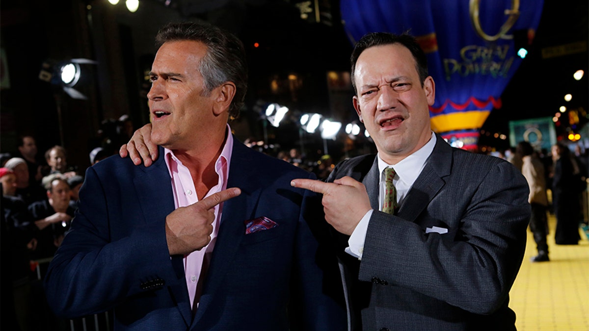(L-R) Actors Bruce Campbell and Ted Raimi share a light moment at the premiere of the Disney movie 