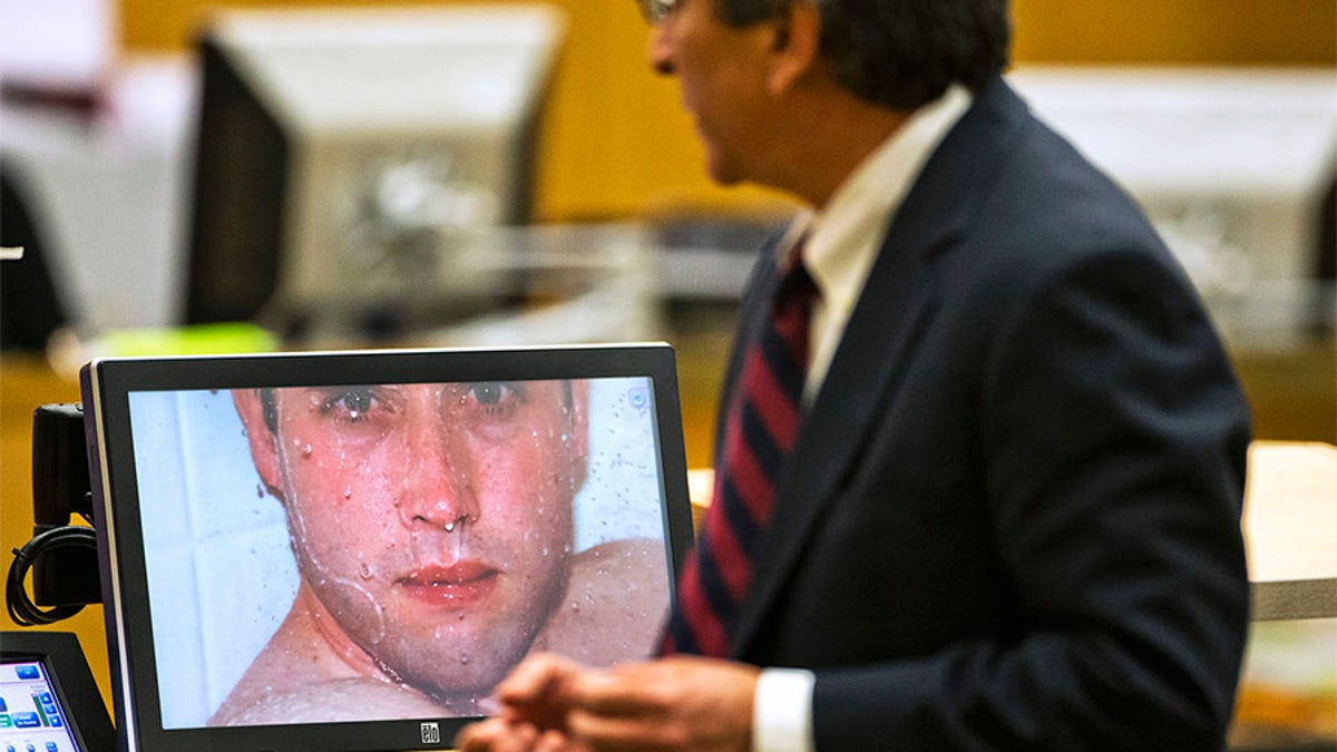 Prosecutor Juan Martinez asks Jodi Arias about a photo she took of Travis Alexander in the shower, moments before she shot him, stabbed him and slit his throat, in Maricopa County Superior Court in Phoenix, Arizona, February 28, 2013. Arias is on trial for the killing of her boyfriend, Travis Alexander, in 2008. REUTERS/Tom Tingle/The Arizona Republic/Pool (UNITED STATES - Tags: CRIME LAW SOCIETY) - TM4E92S17X602