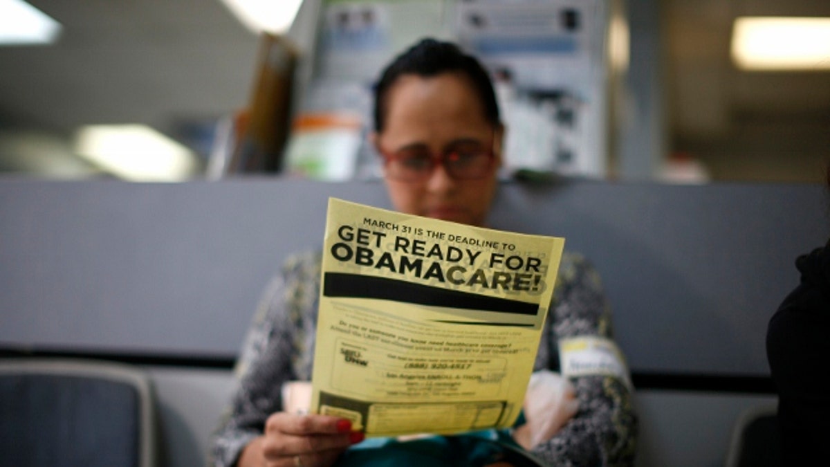 Arminda Murillo, 54, reads a leaflet at a health insurance enrollment event in Cudahy, California March 27, 2014. More than 6 million people have now signed up for private insurance plans under President Barack Obama's signature healthcare law known as Ob