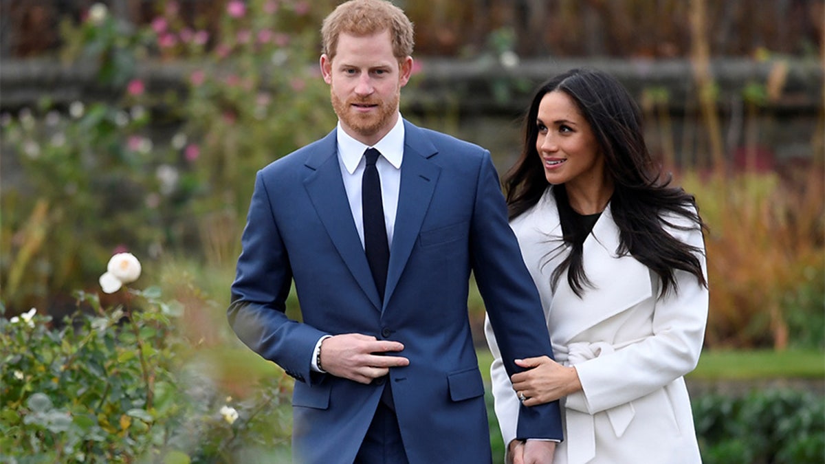 Britain's Prince Harry poses with Meghan Markle in the Sunken Garden of Kensington Palace, London, Britain, November 27, 2017. REUTERS/Toby Melville - RC1ACF5461B0