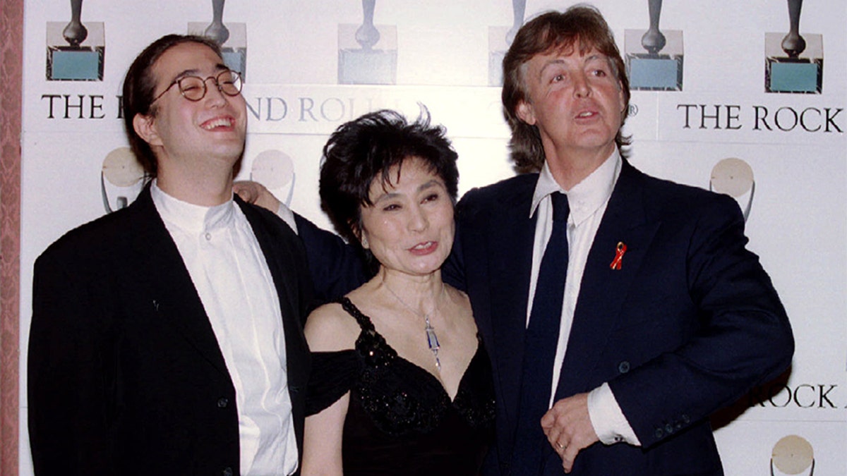 Former Beatle Paul McCartney (R) laughs with Yoko Ono and Sean Lennon after inducting fellow former Beatle John Lennon into the Rock and Roll Hall of Fame in New York on January 20 - PBEAHUNFVAF