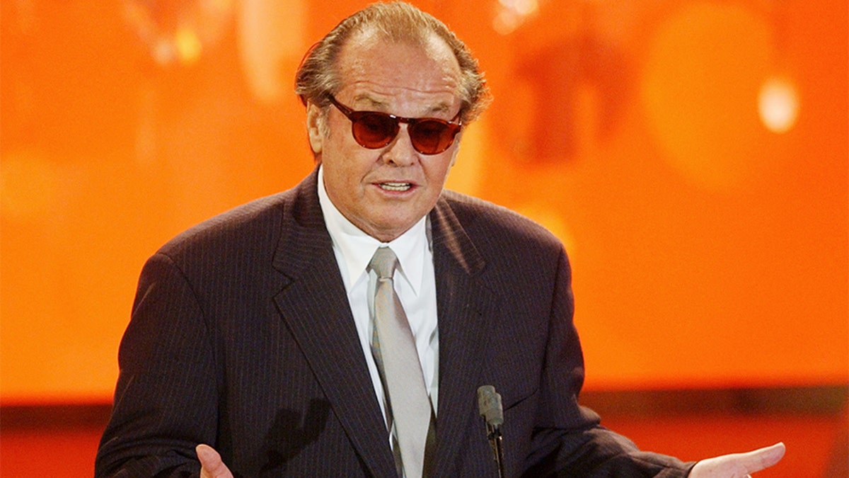 Actor Jack Nicholson accepts the best actor award for his role in
