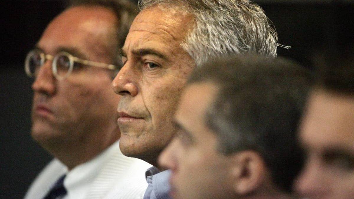 This July 30, 2008 photo shows Jeffrey Epstein in custody in West Palm Beach, Fla. Epstein was suspected nearly a decade ago of paying for sex with underage girls. The FBI abruptly dropped its investigation a few years ago, and Epstein pleaded guilty to a single state charge of soliciting prostitution. He served 13 months in jail. Now, two women who say they were sexually abused as girls by Epstein are hoping a trove of new documents will get the case reopened. (AP Photo/Palm Beach Post, Uma Sanghvi)