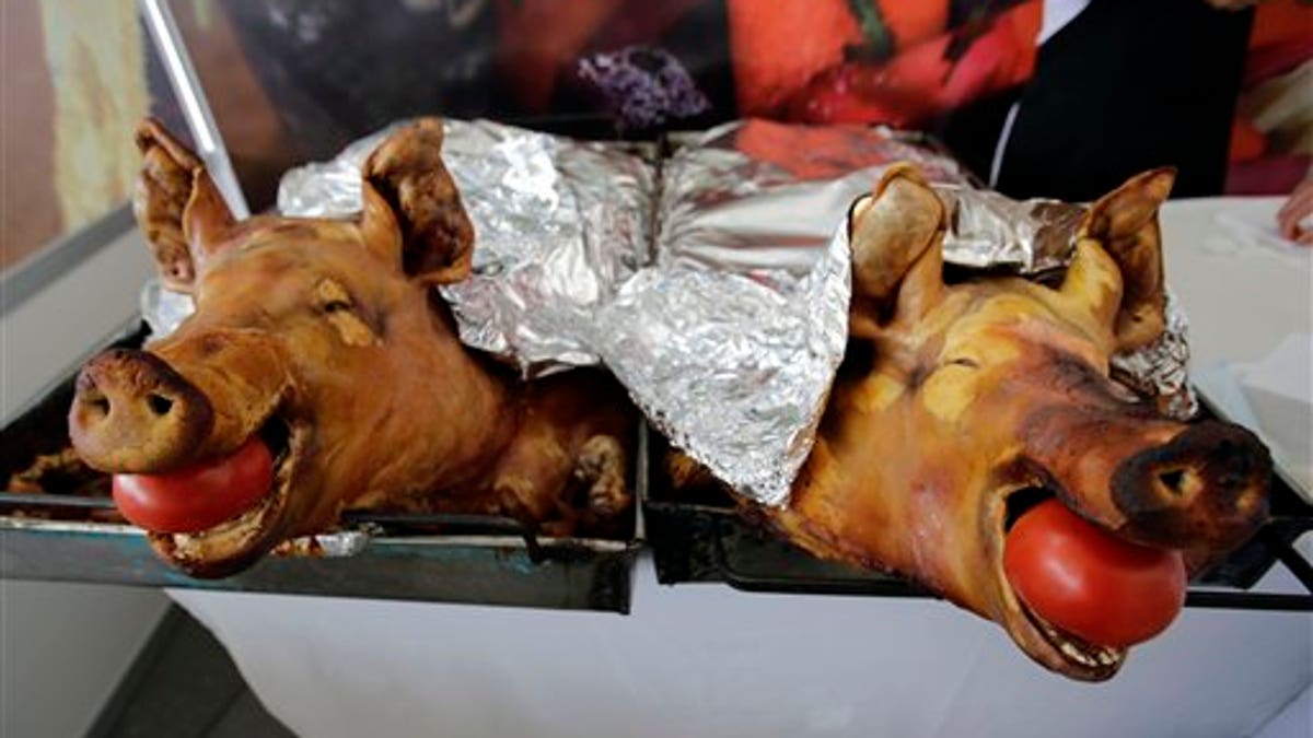 APTOPIX Ecuador Pork Roasting Contest