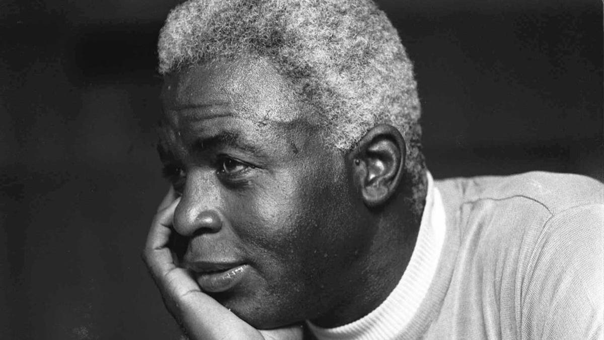 FILE - In this June 30, 1971, file photo, Jackie Robinson poses at his home in Stamford, Conn. Baseball holds tributes across the country on Jackie Robinson Day, Tuesday, April 15, 2014, the 67th anniversary marking the end of the game's racial barrier. (AP Photo/File)