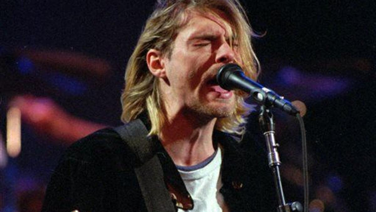 This Dec. 13, 1993 file photo shows Kurt Cobain of the Seattle band Nirvana performing in Seattle, Wash.