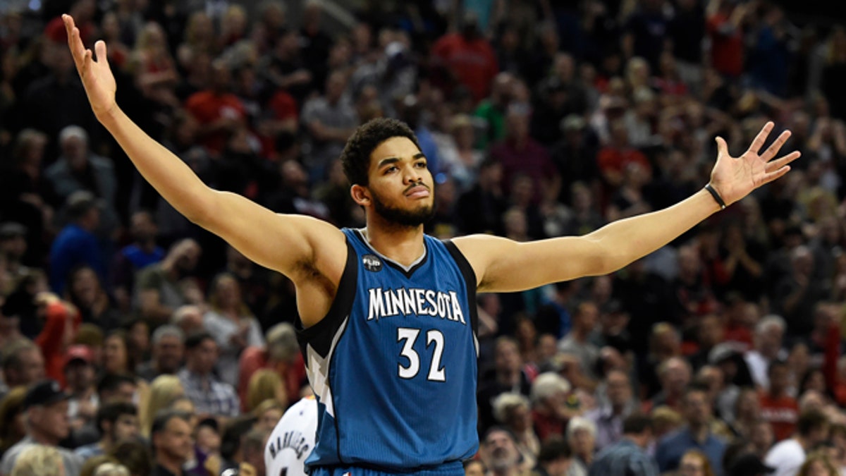 FILE - In this April 9, 2016, file photo, Minnesota Timberwolves center Karl-Anthony Towns celebrates after hitting the game-winning shot in an NBA basketball game against the Portland Trail Blazers in Portland, Ore. Towns is the unanimous winner of the NBA Rookie of the Year award. The league made the announcement Monday, May 16, 2016, giving the Wolves back-to-back honorees.  (AP Photo/Steve Dykes, File)