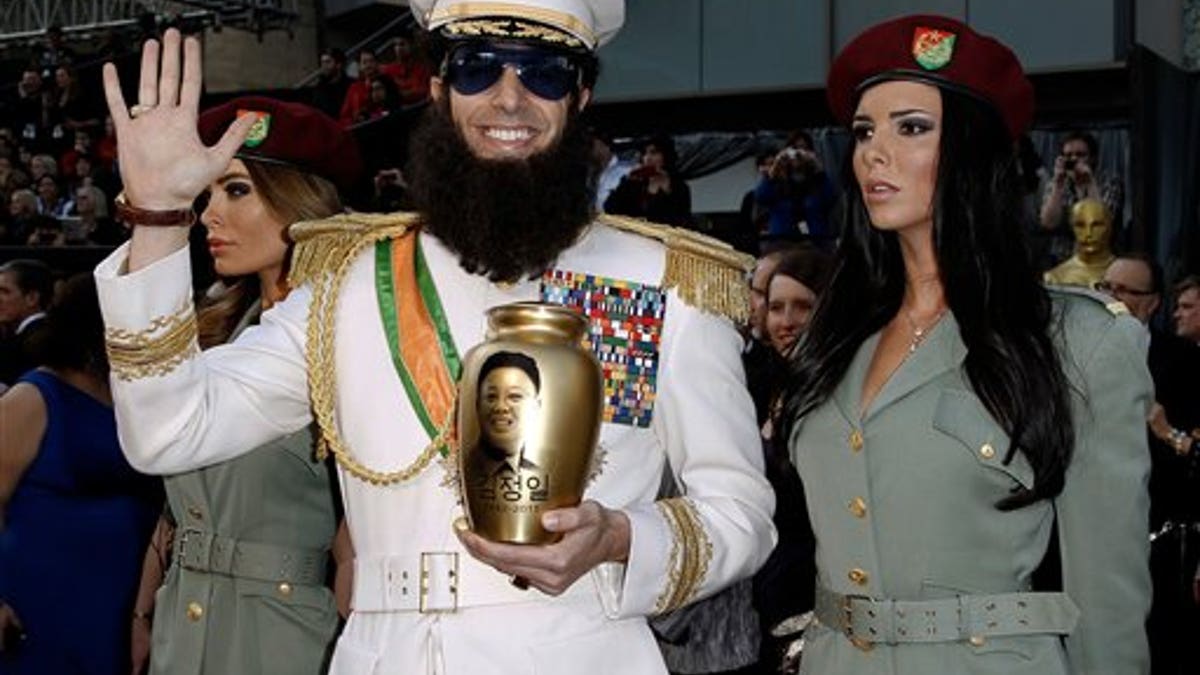 Sacha Baron Cohen, center, and guests arrive before the 84th Academy Awards on Sunday, Feb. 26, 2012, in the Hollywood section of Los Angeles. (AP Photo/Matt Sayles)