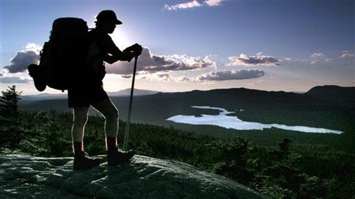 A hiker pauses on the Appalachian Trail in Maine.