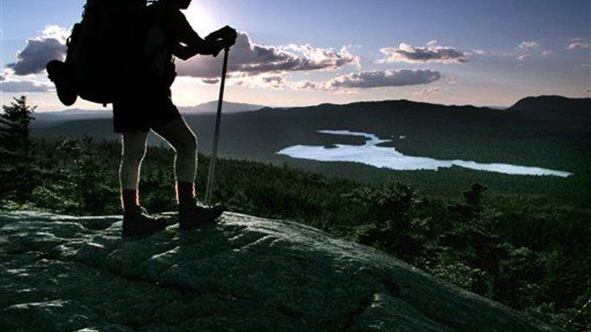 A hiker pauses on the Appalachian Trail in Maine.