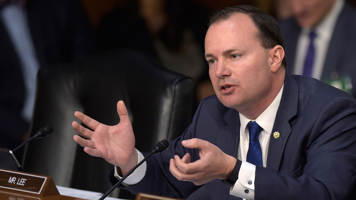 GOP Senator Mike Lee of Utah speaking in front of a microphone