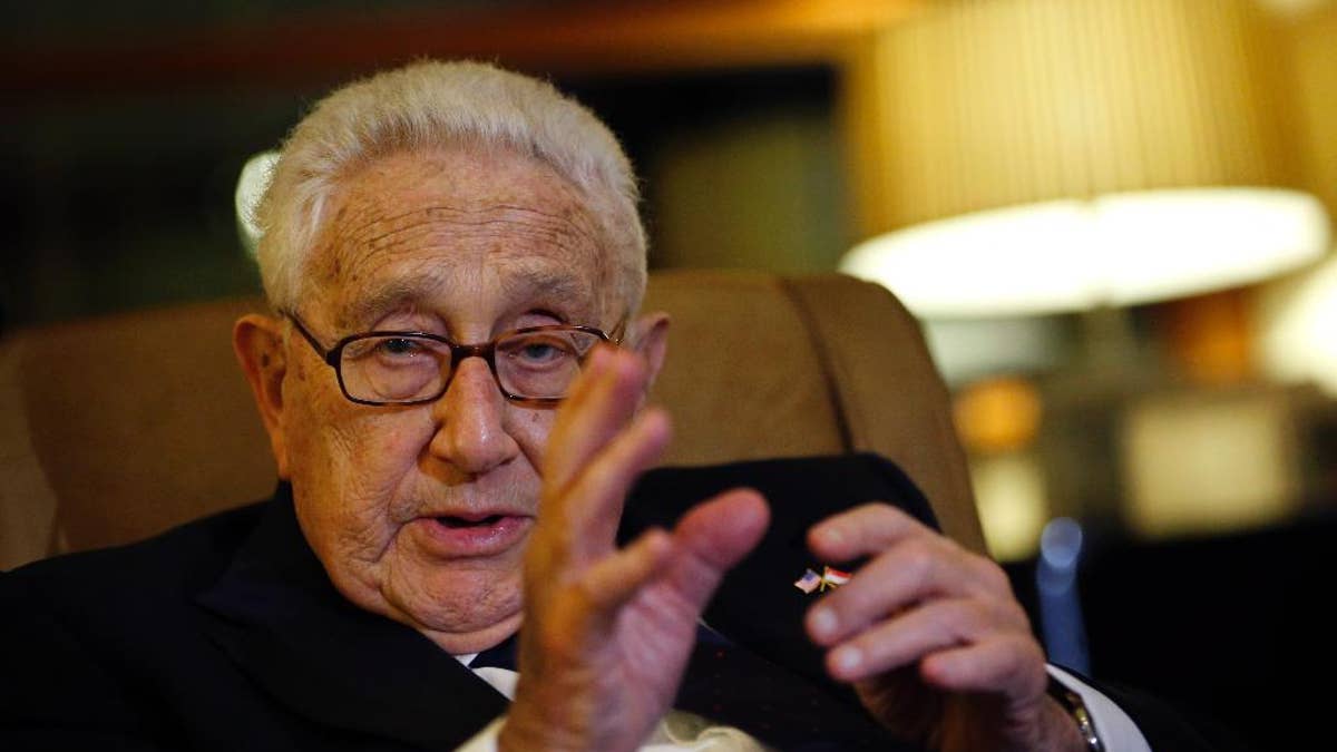 Former U.S. Secretary of State Henry Kissinger speaks to reporters after paying his respects to the late Lee Kuan Yew, Saturday, March 28, 2015, in Singapore. Lee, 91, died Monday at Singapore General Hospital after more than a month of battling severe pneumonia. The government declared a week of mourning for the leader who is credited with transforming the resource-poor island into a wealthy finance and trade hub with low crime and corruption in a region saddled with graft, instability and poverty. (AP Photo/Wong Maye-E)