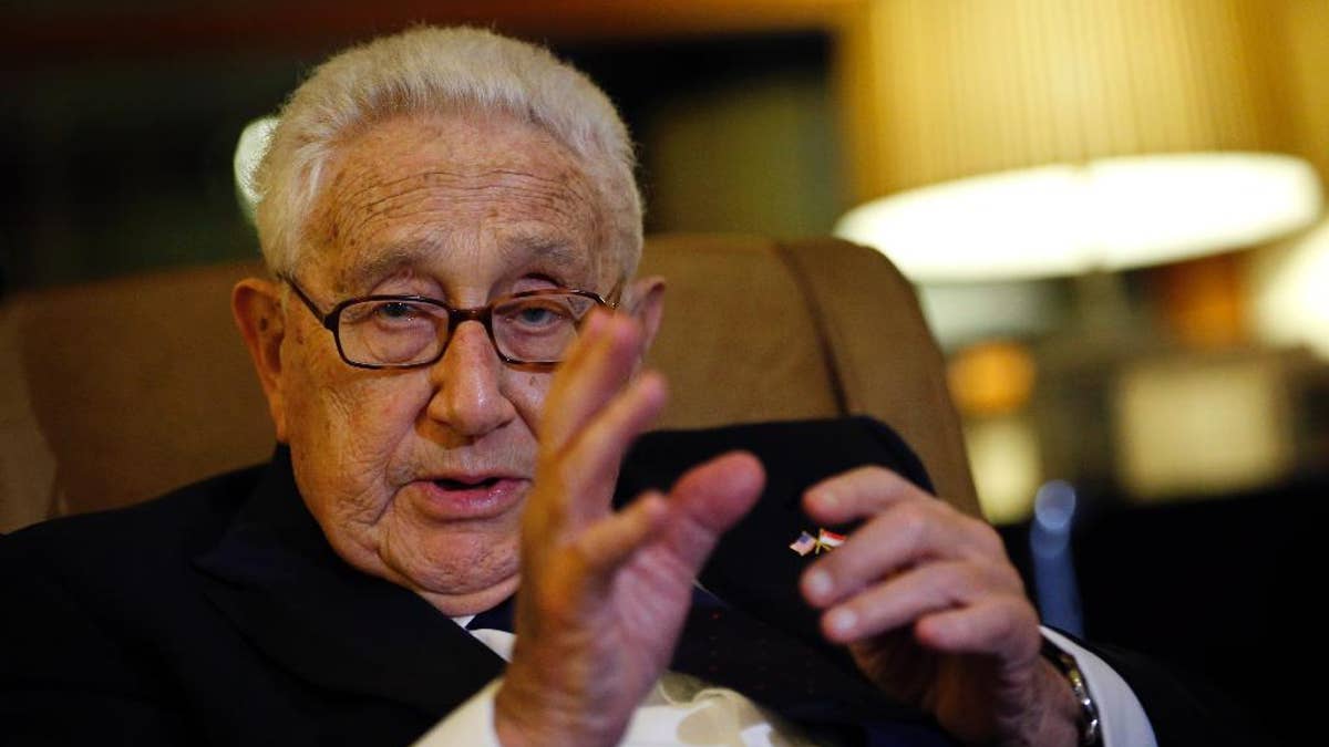 Former U.S. Secretary of State Henry Kissinger speaks to reporters after paying his respects to the late Lee Kuan Yew, Saturday, March 28, 2015, in Singapore. Lee, 91, died Monday at Singapore General Hospital after more than a month of battling severe pneumonia. The government declared a week of mourning for the leader who is credited with transforming the resource-poor island into a wealthy finance and trade hub with low crime and corruption in a region saddled with graft, instability and poverty. (AP Photo/Wong Maye-E)