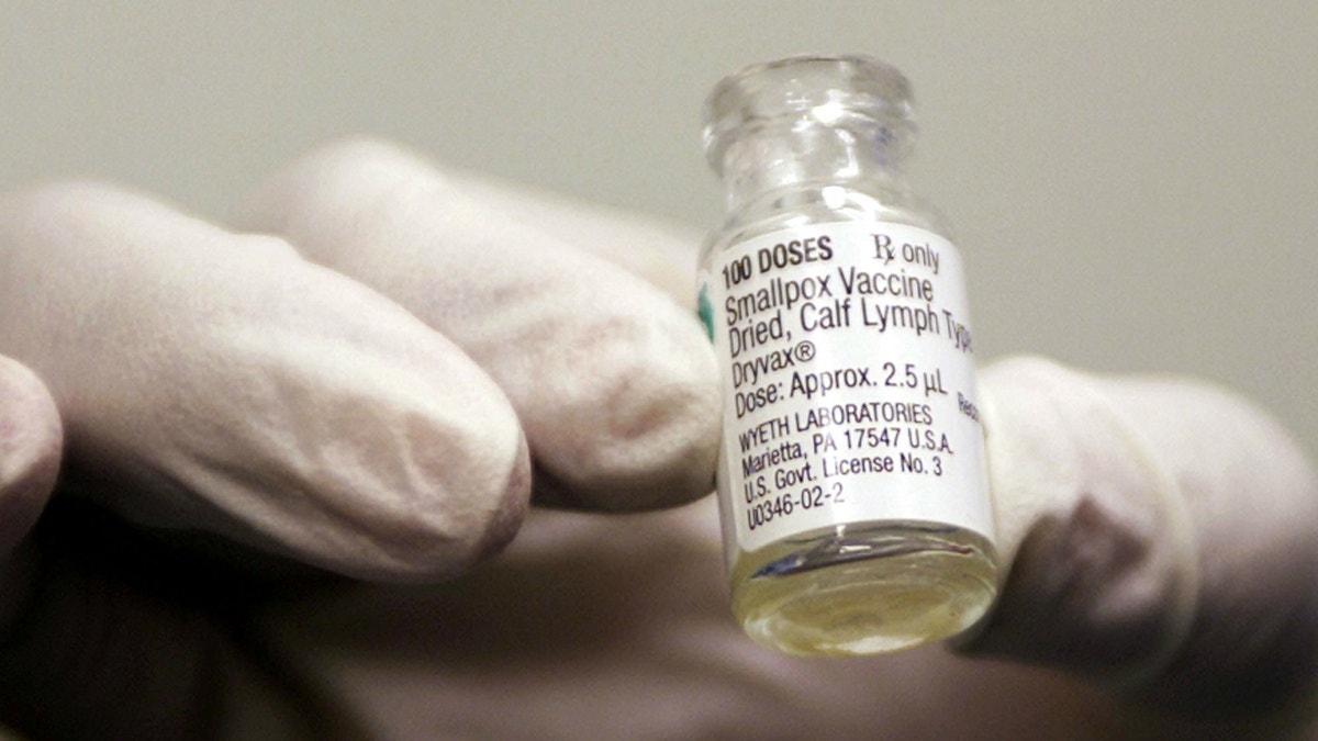 A vile of the smallpox vaccine that is being provided for the military is held up by a health worker at Walter Reed Army Medical Center in Washington.