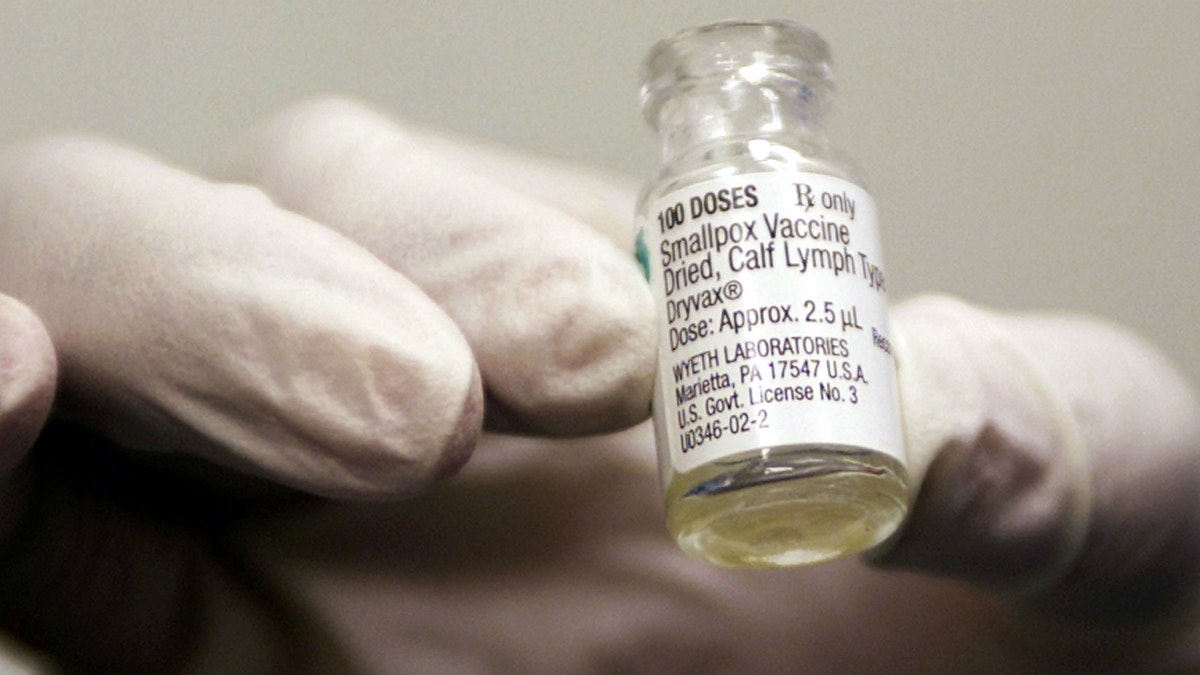 A vile of the smallpox vaccine that is being provided for the military is held up by a health worker at Walter Reed Army Medical Center in Washington.