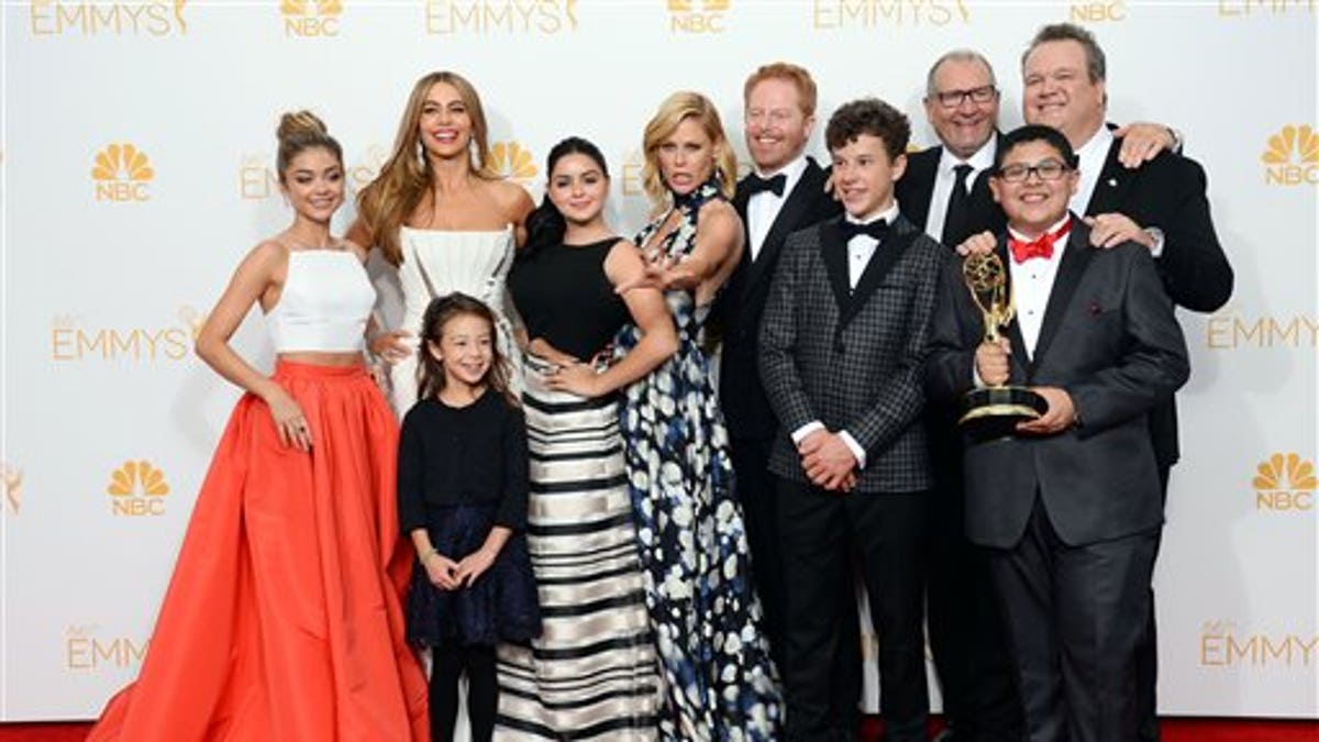 Sarah Hyland, from left, Sofia Vergara, Aubrey Anderson-Emmons, Ariel Winter, Julie Bowen, Jesse Tyler Ferguson, Nolan Gould, Ed O'Neill, Eric Stonestreet and Rico Rodriguez pose in the press room with the award for outstanding comedy series for 