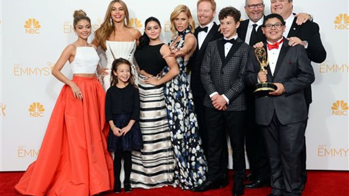 Sarah Hyland, from left, Sofia Vergara, Aubrey Anderson-Emmons, Ariel Winter, Julie Bowen, Jesse Tyler Ferguson, Nolan Gould, Ed O'Neill, Eric Stonestreet and Rico Rodriguez pose in the press room with the award for outstanding comedy series for