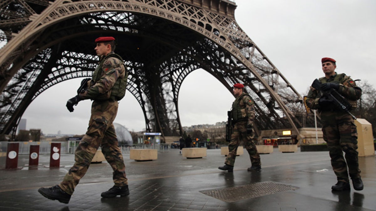 PARIS, FRANCE - JANUARY 09:  Armed security patrols around the Eiffel Tower on January 9, 2015 in Paris, France.  A huge manhunt for the two suspected gunmen in Wednesday's deadly attack on Charlie Hebdo magazine has entered its third day.  (Photo by Dan Kitwood/Getty Images)