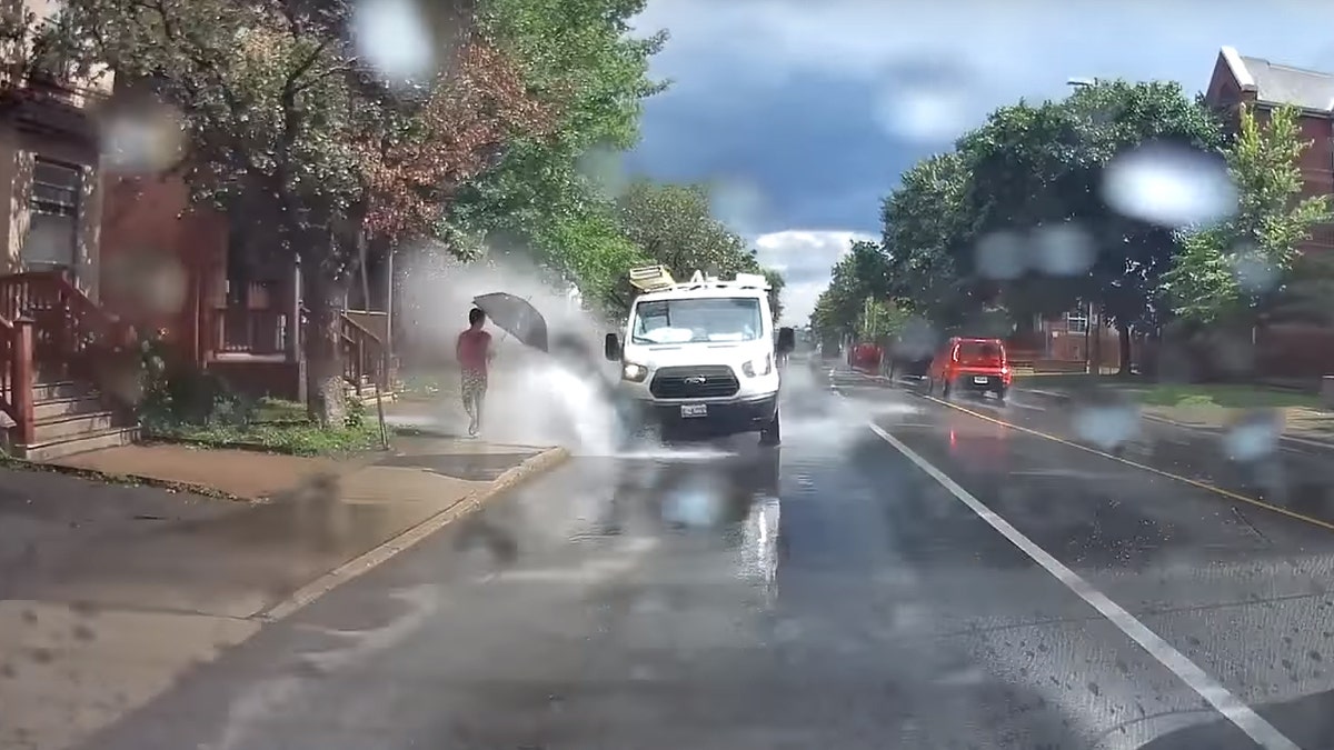 Camera catches van appearing to splash pedestrians