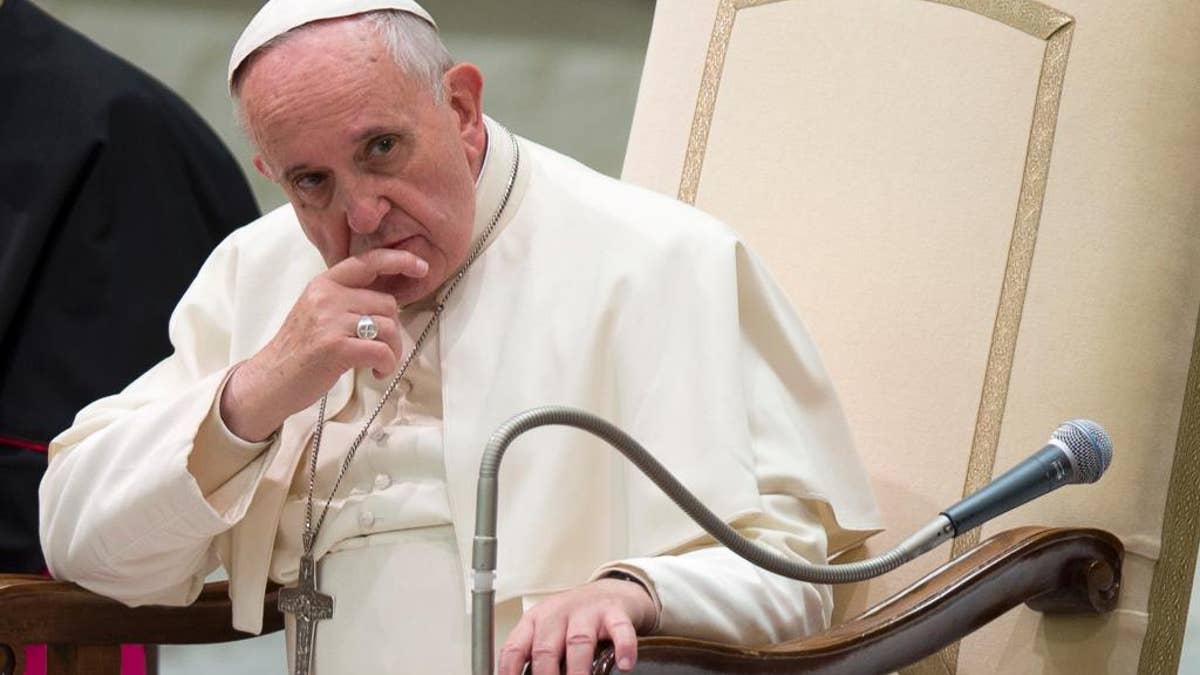 FILE - In this Dec. 4, 2014 file photo, Pope Francis listens to a speech during a special audience he held for members of the FOCSIV Italian Catholic volunteers, at the Vatican. Some Roman Catholic priests and laypeople in Sri Lanka are seeking the postponement of Pope Francis' trip to the island nation next month, citing the visit's closeness to the country's presidential election and possible violence linked to the poll. Francis is due to arrive in Sri Lanka for a three-day visit on Jan. 13, five days after the election. (AP Photo/Andrew Medichini, File)