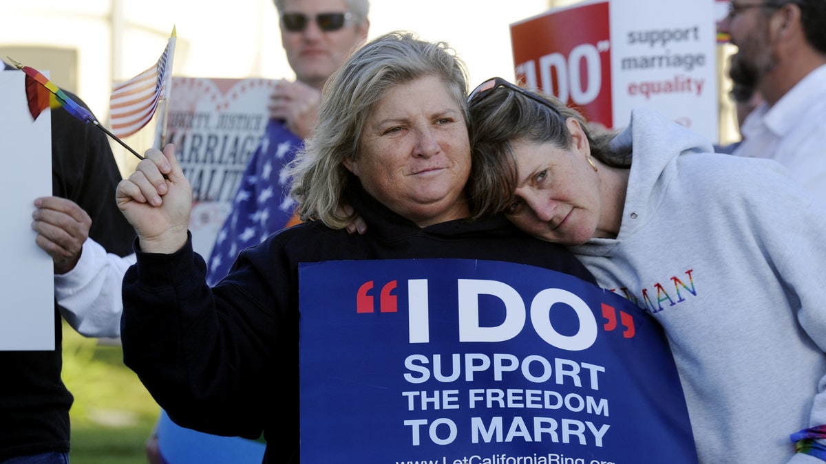 Kim Roberts, left, and her partner Lisa Mayes of Benicia, Calif. participate in a marriage equality rally on Tuesday, March 26, 2013 at the Solano County Government Center in Fairfield before the Supreme Court hears arguments concerning the Defense of Marriage Act after it heard arguments contesting the constitutionality of the California's Proposition 8 on Tuesday. (AP Photo/The Reporter, Joel Rosenbaum)MANDATORY CREDIT