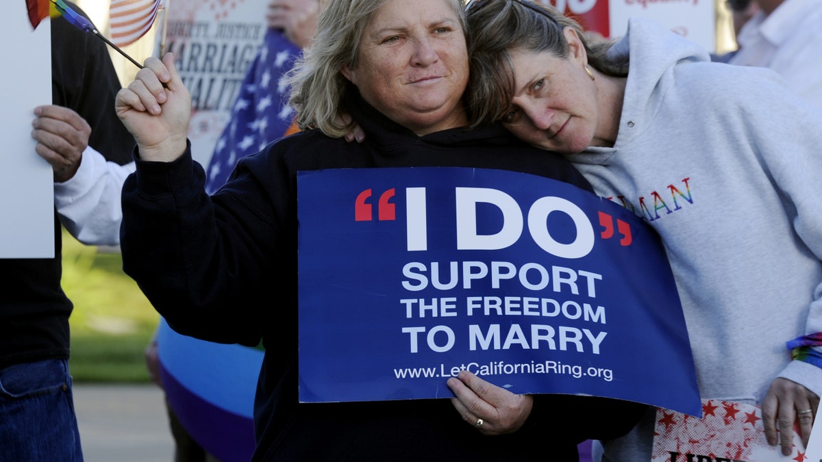 Kim Roberts, left, and her partner Lisa Mayes of Benicia, Calif. participate in a marriage equality rally on Tuesday, March 26, 2013 at the Solano County Government Center in Fairfield before the Supreme Court hears arguments concerning the Defense of Marriage Act after it heard arguments contesting the constitutionality of the California's Proposition 8 on Tuesday. (AP Photo/The Reporter, Joel Rosenbaum)MANDATORY CREDIT