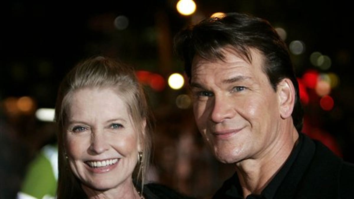 ** CORRECTS ACTRESS TO ACTOR ** FILE - In this Nov. 28, 2005 file photo, actor Patrick Swayze, right, accompanied by his wife Lisa Niemi pose prior to the premiere of his film 
