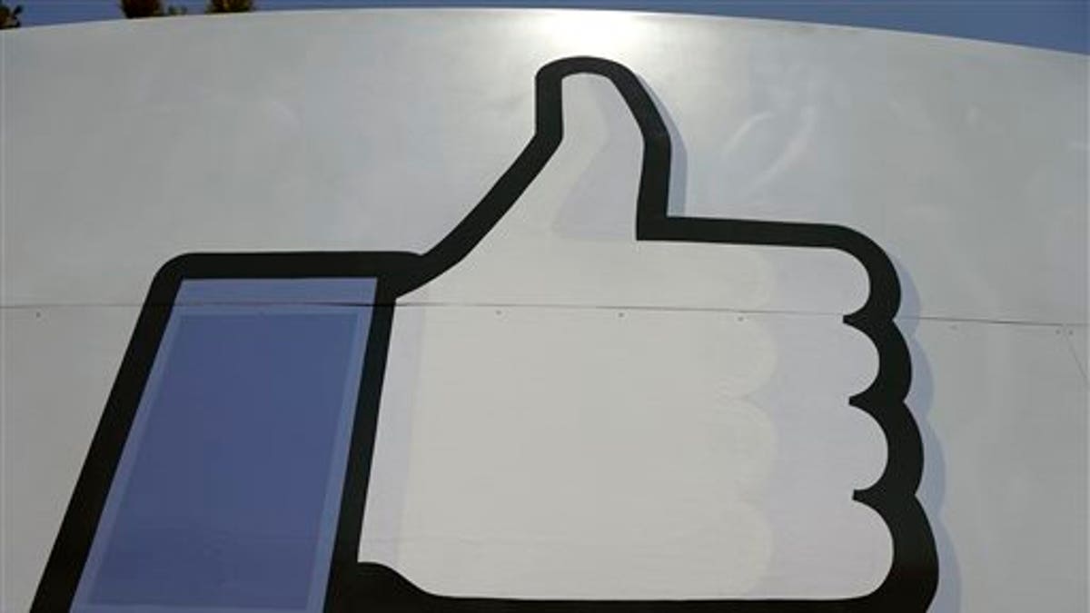 This June 11, 2014 photo shows Facebook's "like" symbol at the entrance to the company's campus in Menlo Park, Calif. For the seventh quarter in a row Facebook beat profit and revenue forecasts, continuing to win more mobile advertising revenue as most users shift to using the site on smartphones and other portable devices, the company announced, Wednesday, Jan. 28, 2015. (AP Photo/Jeff Chiu)