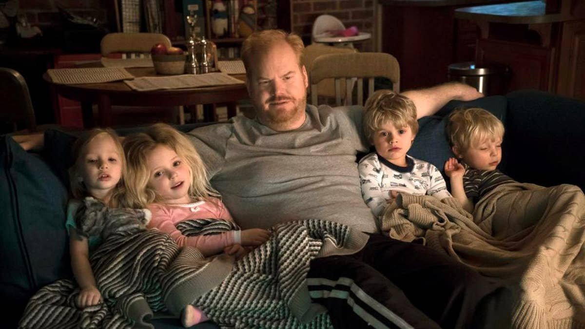 This image released by TV Land shows Jim Gaffigan, center, in a scene from his new comedy series, 